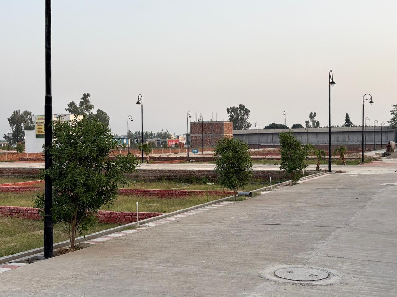 Aerial view of Nirvaana Greens residential plots in Haridwar with internal roads parks clubhouse and landscaped amenities